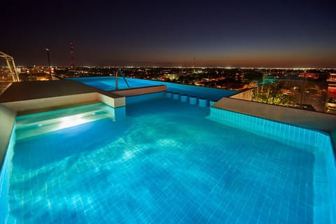Enjoy an evening dip with dazzling city lights all around.