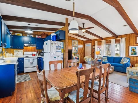 Charming eat-in kitchen with wooden details and comfortable space for shared meals or casual conversations.