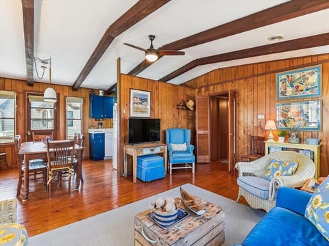 Warm and welcoming living area with rich wood accents, vaulted ceilings, and a large sectional for group comfort.