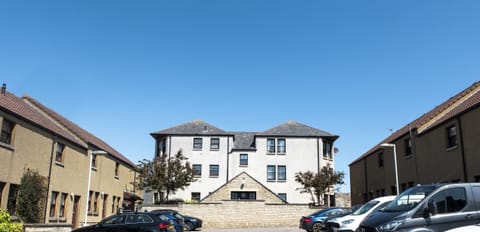 Enjoy a sunny view of this stylish property from the car park, featuring convenient parking and modern architecture