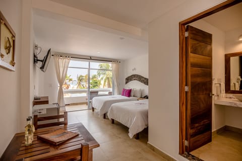 Deluxe Room, 2 Double Beds, Partial Sea View | Bathroom | Shower, free toiletries, hair dryer, towels