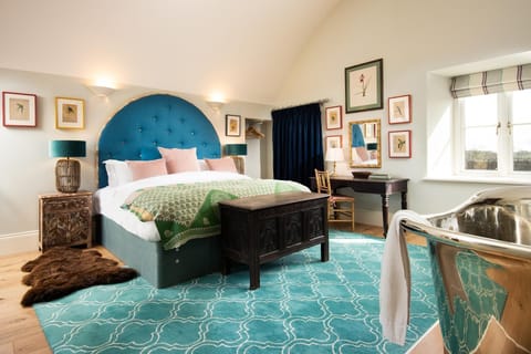 Lakeside Cottage - Emily - a vibrant blue arched headboard hangs above the sumptuous super king bed