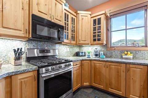 Fully equipped kitchen with stainless appliances, granite counters, and plenty of prep space. TPC-301C