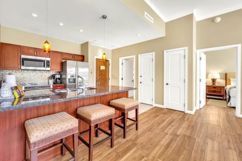 Stylish kitchen island with bar seating and bedroom access nearby. HKK-104