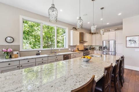 Stylish kitchen featuring a large island for prep and dining.