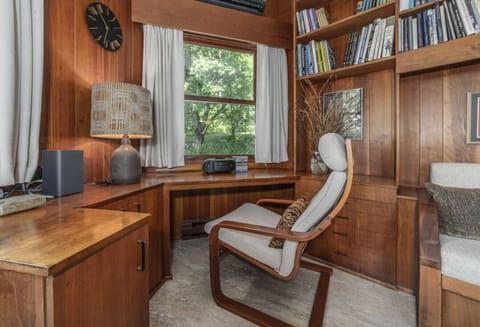 Work or unwind in style! Our den features beautiful wood built-ins, two dedicated workspaces, and cozy furniture for a productive yet relaxing stay.