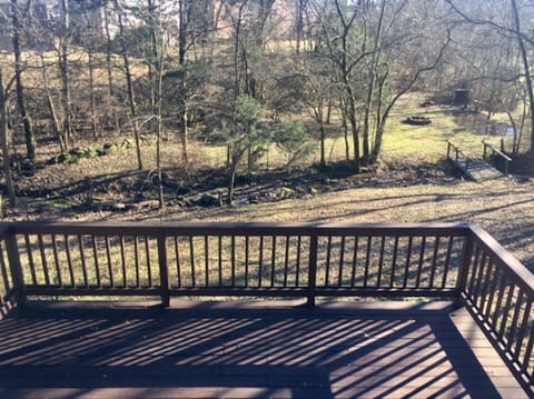 Deck overlooking backyard and creek