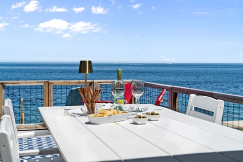 Catch up, kick back, and soak in the ocean air at our beachfront dining table.”