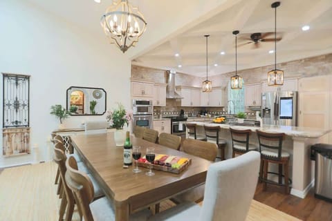 Gather around the elegant dining table for shared meals and meaningful moments. This spacious dining area comfortably seats your group and flows effortlessly into the kitchen and living room. Perfect for family dinners or festive celebrations.