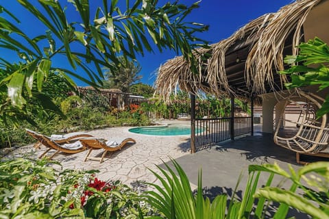 Palapa shade and poolside loungers for the perfect island afternoon.