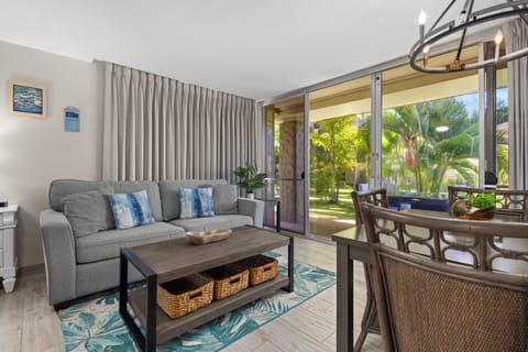 Sink into the plush sofa and enjoy garden views through open glass doors. The space blends comfort with tropical charm, perfect for unwinding after your island adventures.