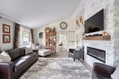 Living room with fireplace and sofa seating.
