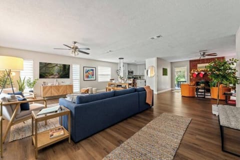 Stylish living room with cozy seating and 65"  smart TV for streaming.

