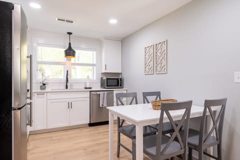 Chic dining area filled with natural light, perfect for family meals or cozy dinners.