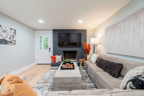 Spacious living room with a large smart TV and cozy sectional for relaxing after a long day.