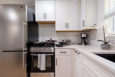 Compact kitchen corner with gas stove, full cookware, and everything you need.