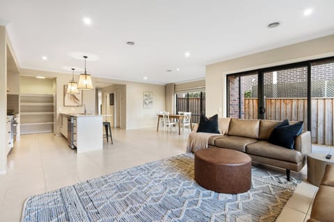 Main living area with flat screen TV, beautiful furnishings and direct access to the kitchen/dining and outdoor area.