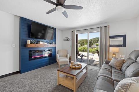 Living area, large smart tv, attached patio, reclining couch, electric fireplace