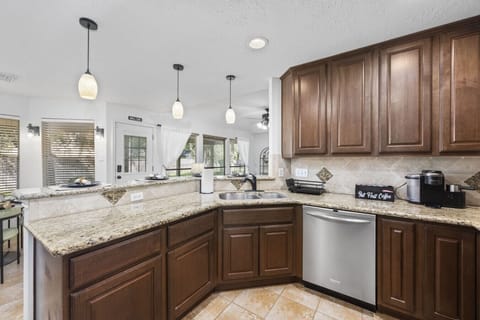 Fully equipped kitchen with granite countertops, stainless appliances, and generous prep space for group cooking.