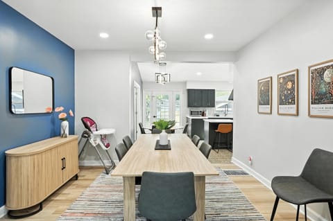 Modern dining room with seating for 8, designer lighting, and direct flow into the stylish kitchen—perfect for shared meals and conversation.