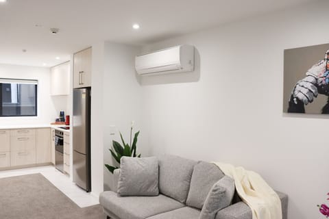 Bright and comfortable living room with a cozy sofa, smart TV, and space to relax after a day out.
