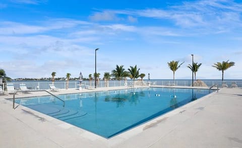 Heated oceanfront pool with lounge chairs.  Beach a towels provide in the condo.