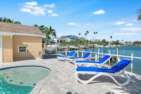 Lounge by the pool with peaceful canal views and plenty of Florida sunshine.
