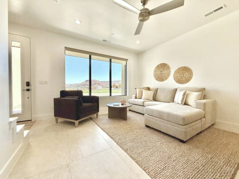 Relax in style! This modern living room offers comfort and stunning views of the Kanab landscape from your Holiday H2 at Catori townhouse.