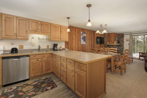 Your spacious kitchen invites culinary adventures with warm wood cabinets, modern appliances, and a generous island for gathering.