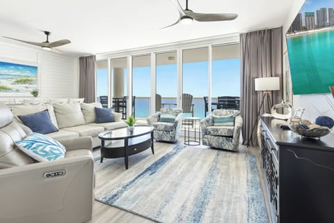 Sink into plush seating while soaking up breathtaking ocean views from your private balcony in this bright, airy living space.