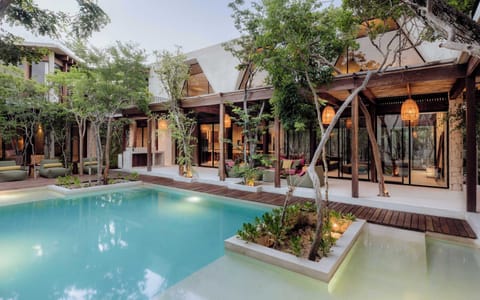 Expansive central pool nestled within a private jungle enclave.