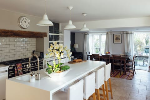 Family kitchen and dining room with doors onto the patio and garden