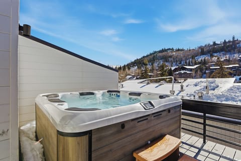 Relax and unwind in the private outdoor hot tub while enjoying scenic mountain views—perfect for après-ski relaxation or stargazing evenings.