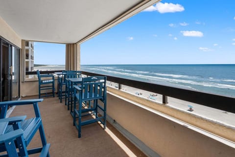 Blue chairs on the oceanfront balcony at Sea Pointe 702, a 3-bedroom Cherry Grove rental from Thomas Beach Vacations