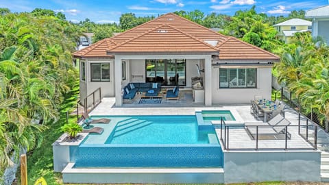 Your paradise awaits!  An infinity pool with baja tanning shelf and water chaise lounges. Al fresco outdoor dining, patio chaise lounges, and a lanai lounge completes your escape!
