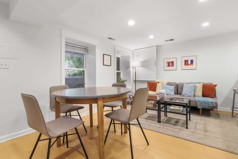 Living room space with dining table and futon which pulls out into additional sleeping space for two people. 