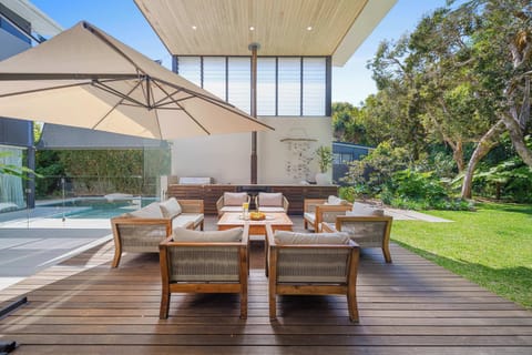 Relax and entertain outdoors with BBQ, fireplace, and lush garden views.