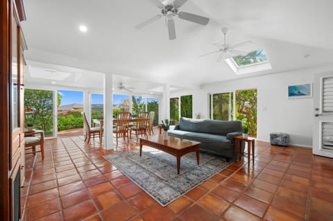 Relax in a bright, open living space with lush garden views right from your couch.