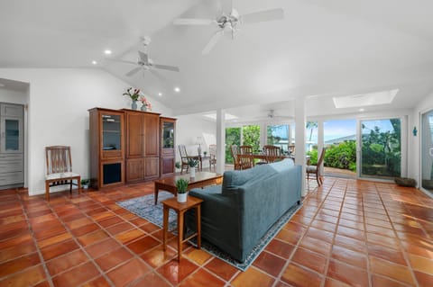 Bright open-concept great room with vaulted ceilings, skylights and sliding doors to the garden