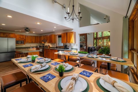 Gather around handcrafted dining tables with seating for 14 plus 3 at the island. The kitchen is fully stocked and ready for your group's favorite meals.