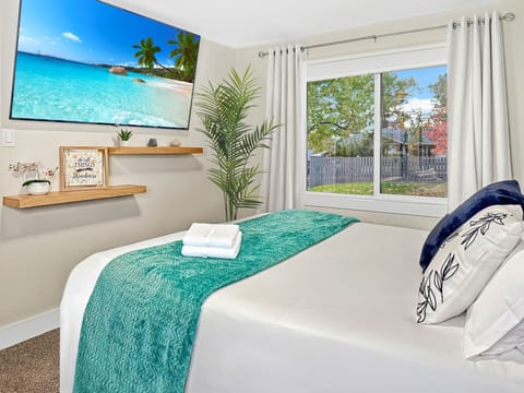 Bright Bedroom with Large Window and Smart TV, v2