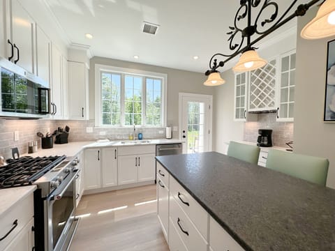 Gourmet kitchen with seating and coffee bar