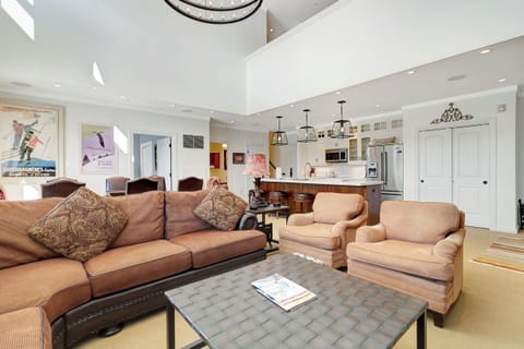 - Spacious open-concept living area with cozy seating   - High ceilings and warm tones for a mountain escape   - Perfect gathering spot after skiing or exploring