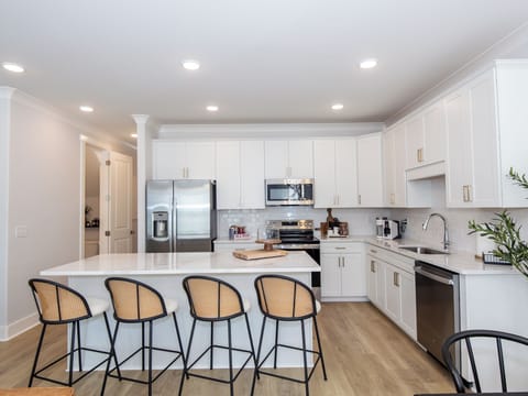 Spacious gourmet kitchen with island seating for 5 and ample storage

