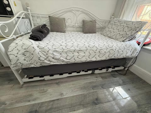DayBed that has a single trundle bed underneath which pulls out to make second single or together a double - please note there is very little room when second bed is pulled out.