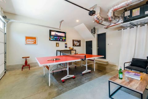 The game room becomes your headquarters after dark: ping pong table, bar seating, and a separate TV for late-night tournaments and hangouts