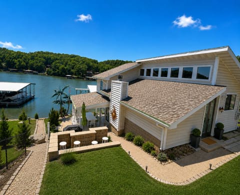 This stunning lakefront home features beautiful waterfront views, spacious outdoor entertaining areas, and the perfect setting for an unforgettable family vacation getaway.