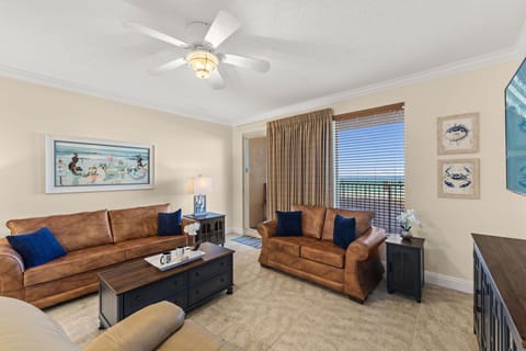 Kick back in your coastal living room w/ plush leather seating, a ceiling fan, & a breezy, beachy vibe.