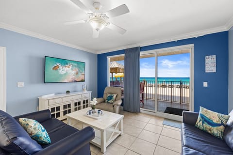 Relax in this coastal living room with ocean views and direct balcony access.