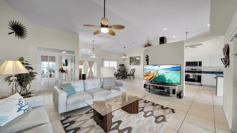 Bright, open living area with cozy seating, view of the dining space, and seamless transition to the modern kitchen.